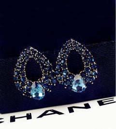 Large teardrop shaped earrings encrusted with faux stones